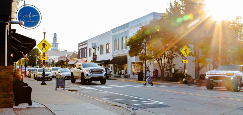 Downtown Apex streetscape with shops and pedestrians in North Carolina.