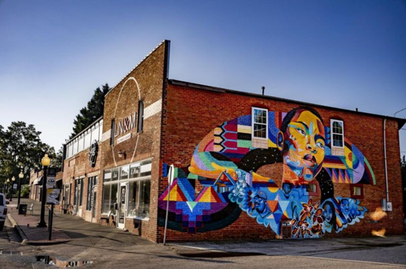 Colorful mural artwork at night on building in Garner North Carolina