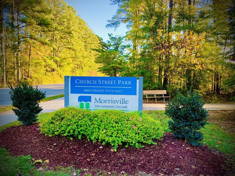 Church Street Park entrance sign in Morrisville, North Carolina with landscaped greenery and wooded surroundings